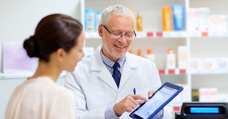 Pharmacist using pharmacy management software